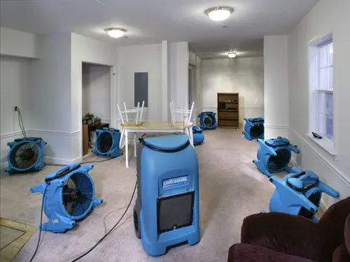 Air movers drying a great room after a storm leak in Calabasas