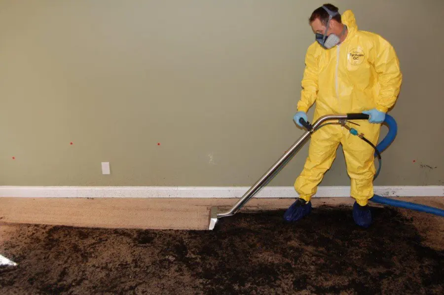 Technician in protective gear cleaning a sewage backup in Calabasas, CA